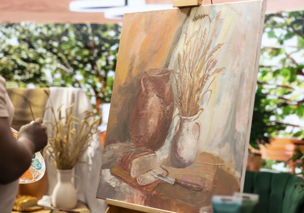 Male artist working on his new masterpiece for the fine art gallery exhibition, using a certain painting technique during his creative process. Beautiful creation on a canvas.